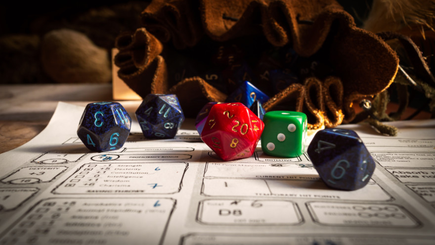 Close Up Of Spilling Out Dice Of Different Kinds From A Dice Bag On A Character Sheet.